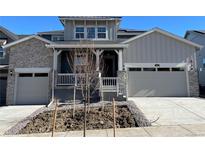Charming home with a well-manicured lawn, a welcoming porch, and a two-car garage at 605 Twilight St, Erie, CO 80516