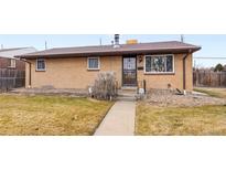 Ranch style home with a well-maintained lawn and walkway at 7481 Bronco Rd, Denver, CO 80221