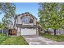 Charming two-story home features a driveway, attached two-car garage, and mature trees at 10963 Bryant St, Westminster, CO 80234