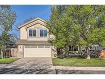 Charming two-story home with a two-car garage, front yard, and mature trees at 10963 Bryant St, Westminster, CO 80234