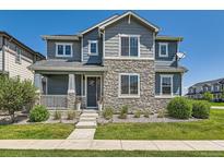 Charming two-story home with stone accents, landscaped front yard and covered entry at 11902 Norfolk Ct, Commerce City, CO 80022