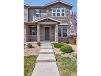 Charming two-story home with stone accents, manicured lawn and inviting entrance at 21944 E Quincy Cir, Aurora, CO 80015