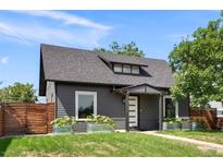 Charming home featuring a well-manicured lawn, gray siding and stylish planters enhancing the curb appeal at 2253 S Fox St, Denver, CO 80223