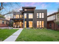 Modern home featuring a well-manicured lawn, large windows, and a second-story balcony at 2838 Tennyson St, Denver, CO 80212