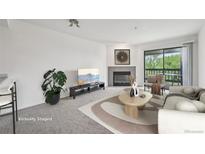 Bright living room features a fireplace, modern decor, and sliding doors to a balcony at 2727 Folsom St # 303, Boulder, CO 80304