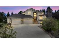 Stunning two-story home with stone accents, grand entrance, and three-car garage at 6398 Lost Canyon Ranch Rd, Castle Rock, CO 80104