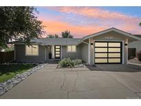 Charming single-story home with a modern garage door and drought resistant rock landscaping at 13030 King Cir, Broomfield, CO 80020