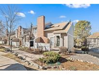 Charming home featuring a brick chimney, well-maintained landscaping, and a welcoming entrance at 2881 W Long Cir # F, Littleton, CO 80120