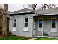 Charming gray brick home with well-maintained lawn and inviting front porch seating at 2737 N Marion St, Denver, CO 80205
