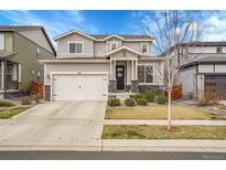 Charming two-story home featuring a two-car garage and well-maintained front yard in a residential neighborhood at 545 W 174Th Pl, Broomfield, CO 80023