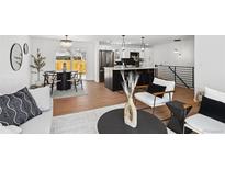 Bright, open living space featuring hardwood floors, an eat-in kitchen and modern finishes at 290 Beryl Way, Broomfield, CO 80020