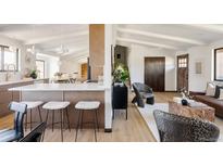 Modern kitchen features white cabinets, quartz countertops, and stainless steel appliances at 3380 S Oak Ct, Denver, CO 80227