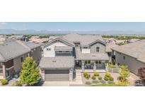 Two-story home with meticulous landscaping and a covered porch, offering great curb appeal and mountain views at 16383 Ute Peak Way, Broomfield, CO 80023