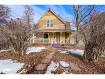 Charming craftsman home with a wrap-around porch and mature landscaping at 3039 W 22Nd Ave, Denver, CO 80211