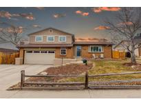 Charming brick two-story home featuring a two-car garage and well-maintained front yard with inviting curb appeal at 7577 Coors Ct, Arvada, CO 80005