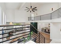 Bright open concept living and dining area with vaulted ceilings and modern staircase at 7309 Windsor Dr, Boulder, CO 80301