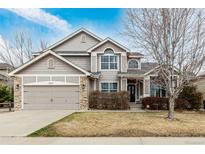 Charming home with a two-car garage, stone accents, and well-maintained landscaping at 664 Clarendon Dr, Longmont, CO 80504