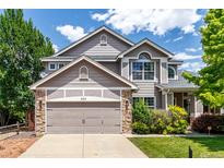 Charming two-story home featuring a two-car garage and well-maintained landscaping under a sunny sky at 664 Clarendon Dr, Longmont, CO 80504