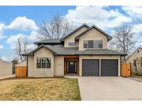 Beautiful two-story home featuring a stone and stucco facade, two-car garage, and manicured lawn at 3350 S Eudora St, Denver, CO 80222