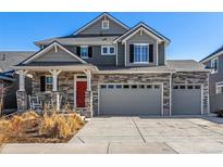 Charming two-story home with stone accents, grey siding, and an inviting front porch at 4104 N Picadilly Ct, Aurora, CO 80019