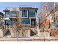 Modern home with a rooftop deck, large windows and concrete steps leading up to the entrance at 3333 Osage St, Denver, CO 80211