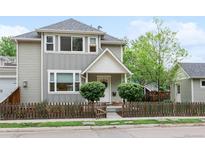 Charming two-story home features a quaint front porch and a decorative picket fence at 208 N Foote Ave, Lafayette, CO 80026