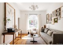 Bright living room showcasing hardwood floors, large windows, modern decor, and comfortable seating at 321 Fox St, Denver, CO 80223