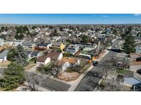 Expansive aerial view of a suburban neighborhood highlighting rooftops and tree cover in a well-established community at 19000 E Mansfield Dr, Aurora, CO 80013