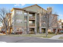Inviting three-story condo building with stone accents, balconies, and well-maintained landscaping at 15455 Canyon Rim Dr # 307, Englewood, CO 80112