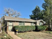 Charming single-story home with well-maintained landscaping and neutral siding at 200 Perry St, Denver, CO 80219
