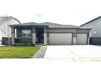 Charming home with stone accents, well-kept lawn, and a three-car garage for ample parking at 13432 Broad Wing Dr, Parker, CO 80134