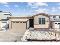 Charming single-Gathering home featuring a two-car garage and inviting curb appeal with partial snow in the yard at 9132 Telluride Ct, Commerce City, CO 80022