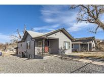 Charming single-story home featuring a gray exterior, a red front door, and a gravel front yard at 2795 W Ellsworth Ave, Denver, CO 80219