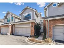 Charming townhome featuring a well-manicured lawn and an attached one car garage at 7696 S Monaco E Cir, Centennial, CO 80112