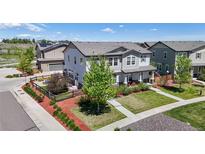 Charming two-story home with manicured lawn, beautiful landscaping, and a welcoming front porch at 10016 Hough Pt, Parker, CO 80134