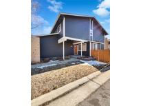 Two-story home featuring a covered porch, landscaped front yard, and brick accents at 4020 S Atchison Way, Aurora, CO 80014