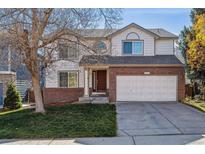 Charming two-story home with brick accents, a well-maintained lawn, and attached two car garage at 9457 Morning Glory Ln, Highlands Ranch, CO 80130