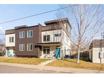 Modern townhome with a blue front door, well-maintained lawn, and contemporary design at 3270 Vrain St, Denver, CO 80212
