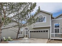 Inviting two-story townhome with a gray-beige exterior, an attached garage, and a landscaped yard at 3228 47Th, Boulder, CO 80301
