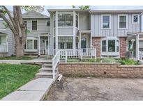 Charming townhome with brick and siding exterior, complemented by a well-maintained front yard at 8136 Washington St # 141, Denver, CO 80229