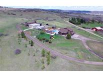 Expansive property featuring a large home, pool, outbuildings, and plenty of land at 1063 Clarke Ct, Castle Rock, CO 80109