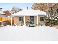 Cute bungalow with a snow-covered front yard and charming porch at 1171 Quebec St, Denver, CO 80220