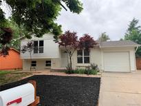 Charming raised ranch-style home with mature trees and a well-manicured front yard at 2108 S Idalia St, Aurora, CO 80013