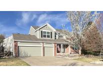 Charming two-story home with a three-car garage and well-maintained lawn and landscape at 18168 E Caley Cir, Aurora, CO 80016