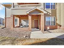 Charming condo with a covered front entrance and space for outdoor seating on the patio at 12764 Ironstone Way # 103, Parker, CO 80134