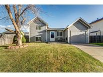 Charming home featuring a well-maintained lawn, a garage, and inviting curb appeal at 16980 E Stanford Ave, Aurora, CO 80015