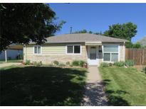 Charming single-story home with a well-manicured lawn and inviting walkway at 1271 Xapary St, Aurora, CO 80011