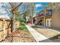 Inviting backyard path leading to townhomes with stairs to outdoor decks on a sunny day at 5300 E Cherry Creek South Dr # 124, Denver, CO 80246