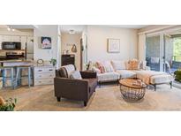 Inviting living room featuring a comfortable sectional sofa and decor with access to an outdoor patio at 5300 E Cherry Creek South Dr # 124, Denver, CO 80246