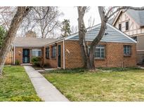 Charming brick home featuring a well-maintained lawn and mature trees at 482 N Humboldt St, Denver, CO 80218